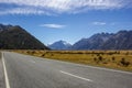 Asphalt mountain road near Lake Pukaki near Mount Cook, on a background of blue sky with clouds, Mount Cook, South Island, New Royalty Free Stock Photo