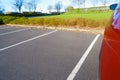 Asphalt parking near the lawn in a european city. Road marking in an parking. Empty parking lot with foliage wall in the Royalty Free Stock Photo