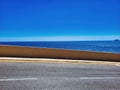 Asphalt pavements and square floor tiles under the blue sky and. The road, the ground and the blue sky. On the road. Panoramic Royalty Free Stock Photo