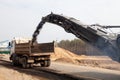 asphalt paver machine and dump truck work on road construction Royalty Free Stock Photo