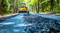 Asphalt paver machine laying fresh asphalt on the surface of a newly constructed road