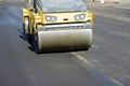 Asphalt paver machine on the road repair site road renewal process, construction working.