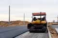 Asphalt paver machine during road work. Road Machinery at construction site for paving works. Screeding the sand for road