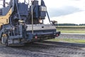 Asphalt paving equipment. Professional asphalt paver close-up. Construction of new roads and road junctions. Heavy construction