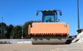 Asphalt paving machine in a road construction site. Front view of its roller with copy space Royalty Free Stock Photo