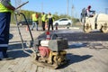 Vibrating plate compactor on the road Royalty Free Stock Photo