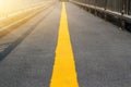 Asphalt with perspective yellow road line, soft focus