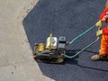 Asphalt plate compactor tool on street Royalty Free Stock Photo