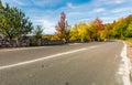 Asphalt road through autumn forest in mountains Royalty Free Stock Photo