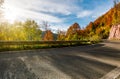 Asphalt road through autumn forest in mountains Royalty Free Stock Photo