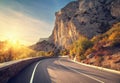 Asphalt road in autumn forest at sunrise. Crimean mountains Royalty Free Stock Photo