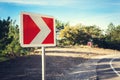 Asphalt road in autumn forest at sunrise and road sign Royalty Free Stock Photo