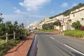 Asphalt Road and Beachfront Buildings and Blue Cloudy Skyline