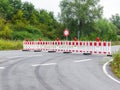 Asphalt road is blocked with a red and white plastic barriers due to construction work. Roadwork, no passage prohibited Royalty Free Stock Photo