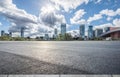 Asphalt road with city buildings skyline background Royalty Free Stock Photo