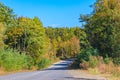 Asphalt road through colorful deciduous forest Royalty Free Stock Photo