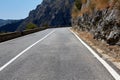 Asphalt road. Colorful landscape with beautiful mountain road with a perfect asphalt. High rocks, blue sky at sunrise in Royalty Free Stock Photo