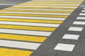 Asphalt road crosswalk with marking lines white and yellow stripes Royalty Free Stock Photo