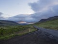 Asphalt road curve through empty northern landscape with green g Royalty Free Stock Photo