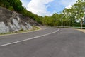 Asphalt road curve pass through the mountain and tree