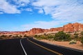 Asphalt road curving round corner with steep desert rock formations in Utah Royalty Free Stock Photo