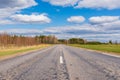 Asphalt road field and forest sunny white cloud blue sky shot Royalty Free Stock Photo