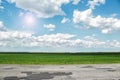 Asphalt road and green field at sunny summer day Royalty Free Stock Photo