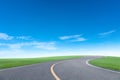 Asphalt road with green grass field scenery blue sky white cloud