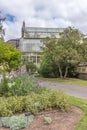 Asphalt road with green plants near a greenhouse in National Botanic Gardens, vertical shot Royalty Free Stock Photo