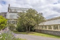 Asphalt road with green plants near a greenhouse in National Botanic Gardens, vertical shot Royalty Free Stock Photo