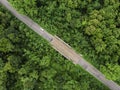 Asphalt road with green tropical forest at countryside of Thailand