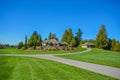 Asphalt road junction running over landscape with big farmer`s house on the hill Royalty Free Stock Photo