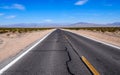 Asphalt road leading through steaming hot landscape of Death Valley National Park, California, USA. Super hot sunny day Royalty Free Stock Photo