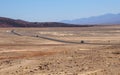 Asphalt road leading through steaming hot landscape of Death Valley National Park, California, USA. Super hot sunny day Royalty Free Stock Photo