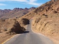 Asphalt road leading through steaming hot landscape of Death Valley National Park, California, USA. Super hot sunny day Royalty Free Stock Photo