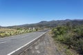 Asphalt road leading to the mountains on a Sunny day. Mountain l Royalty Free Stock Photo