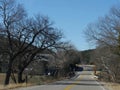 Asphalt road with leafless trees in winter time in Oklahoma Royalty Free Stock Photo