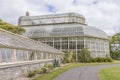 Asphalt road with meadows and plants near a greenhouse in National Botanic Gardens Royalty Free Stock Photo