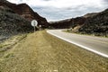 Asphalt road between mountains, distant routes that curve into new places. Trips to the unknown.