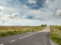 Asphalt road with new and old surface, Blue colorful sky. green fields Royalty Free Stock Photo