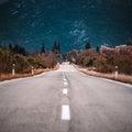 Asphalt road panorama in countryside on cloudy day. Road in forest under dramatic cloudy sky. Royalty Free Stock Photo