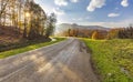 Asphalt road passing through an autumn forest in the mountains Royalty Free Stock Photo