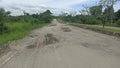 Asphalt Road is potholes, broken, cracked, raised and dangerous. caused by poor quality asphalt roads and high vehicle loads