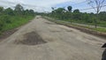 Asphalt Road is potholes, broken, cracked, raised and dangerous. caused by poor quality asphalt roads and high vehicle loads