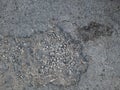 Asphalt road potholes in Indonesia with gravel