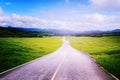 Asphalt road with rice field in countryside along to blue sky.