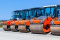 Red road rollers parked on the unfinished road construction site Royalty Free Stock Photo