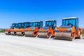 Red road rollers parked on the unfinished road construction site Royalty Free Stock Photo