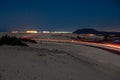 Asphalt road running through the sandy desert at night Royalty Free Stock Photo