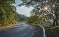 Asphalt road sharp curve along with tropical forest zigzag ahead